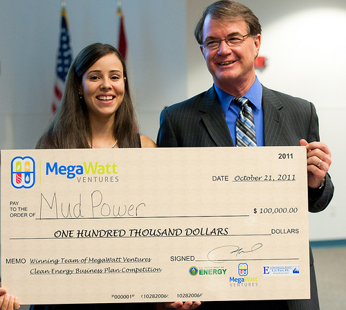 Dr. Cheryl Martin, Deputy Director for Commercialization for ARPA-E, Maryln Colon, Mud Power, and Dr. Tom O'Neal, VP of Research and Commercialization at UCF are all smiles as they pose for the awarding of the $100,000 grand prize.